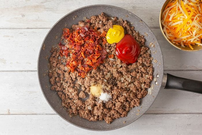 salt, pepper, garlic powder, pepper and diced, cooked bacon added to the beef in a large pan
