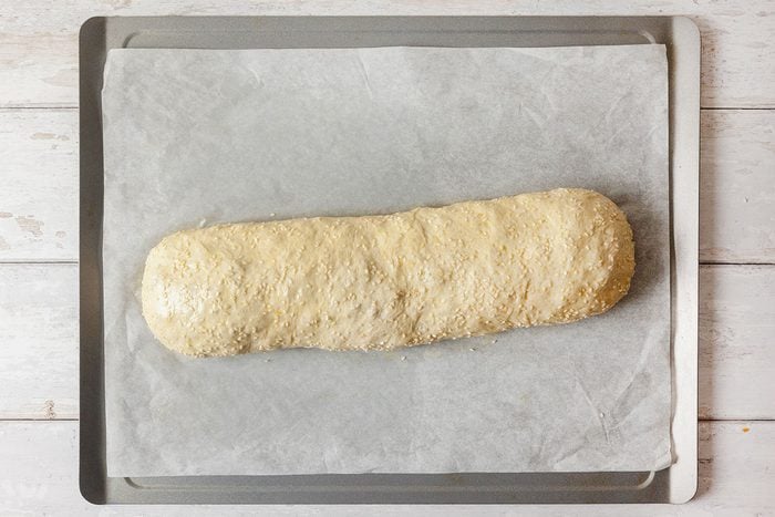 Pizza dough being rolled up
